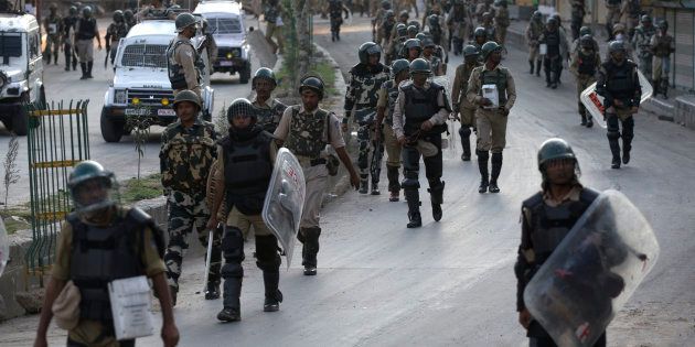 Indian paramilitary soldiers walk back towards their base camp after a day long curfew in Srinagar.