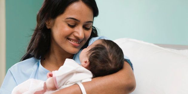 Portrait of mother embracing newborn child (2-5 months)