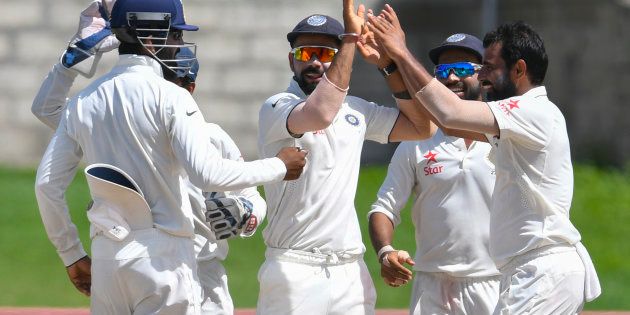 Virat Kohli (C) and Mohammed Shami (R) of India celebrate the dismissal of West Indies during the 5th and final day of the 3rd Test match.