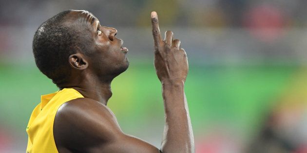 Usain Bolt points skyward before the start of his 100-meter semifinal on Sunday, Aug. 14, 2016 at the Rio Games in Brazil. Later that night, Bolt won the final. (Mark Reis/Colorado Springs Gazette/TNS via Getty Images)