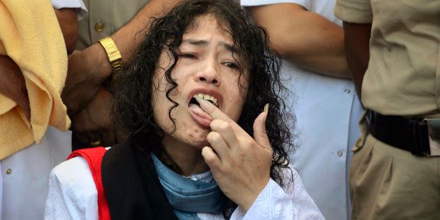 Irom Sharmila licks honey from her hand to break her fast.