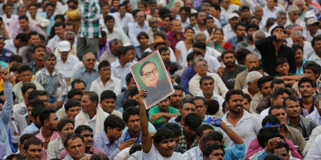 A man displays a portrait of Dalit leader Bhim Rao Ambedkar as hundreds of members of Dalit community gather for a rally in Una.