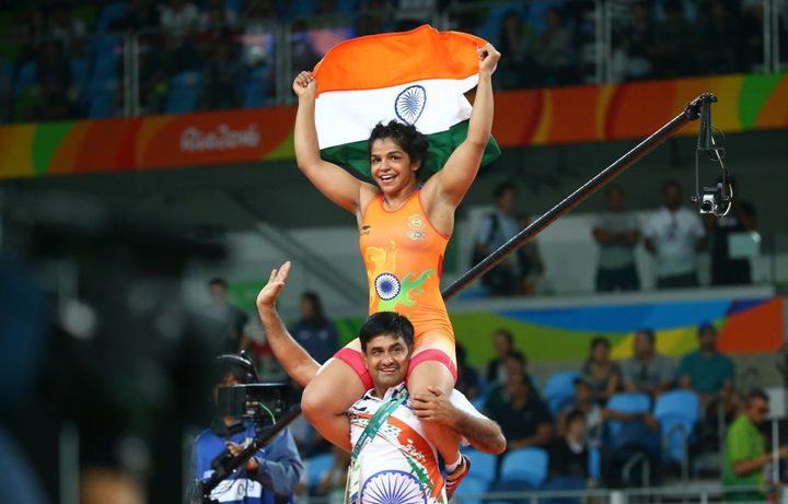 Sakshi Malik celebrates with her coach after winning the bronze medal.