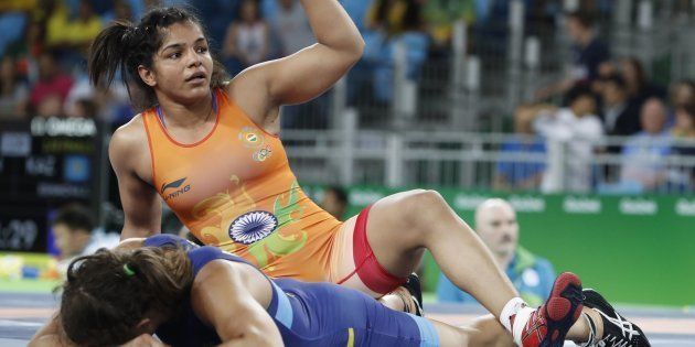 India's Sakshi Malik (top) celebrates during her fight against Sweden's Malin Johanna Mattsson in the women's 58kg freestyle qualification match on 17 August, 2016 at the Rio Games.