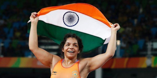 India's Sakshi Malik celebrates after winning against Kirghyzstan's Aisuluu Tynybekova in their women's 58kg freestyle bronze medal match on 17 August, 2016 at the Rio Games.