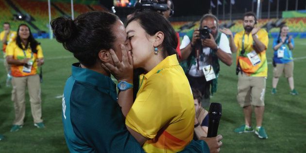 Volunteer Marjorie Enya (R) and rugby player Isadora Cerullo of Brazil kiss after proposing marriage after the Women's Gold Medal Rugby Sevens match between Australia and New Zealand.