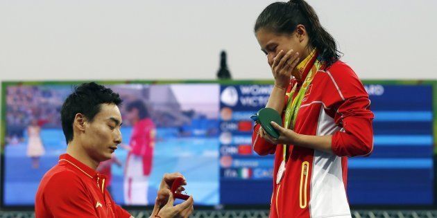 Silver medallist China's He Zi receives a marriage proposal from Olympic diver Qin Kai of China.