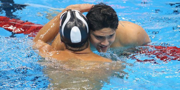 Gold medalist Joseph Schooling of Singapore hugs silver medalist Michael Phelps of USA following the Men's 100m Butterfly final on day 7 of the Rio 2016 Olympic Games.
