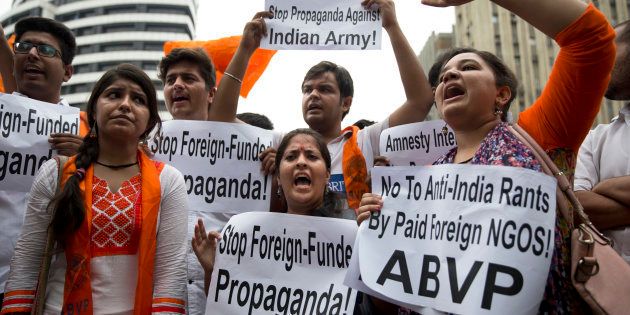 Supporters of Akhil Bharatiya Vidyarthi Parishad (ABVP), the students wing of the ruling Bharatiya Janata Party, shout slogans against human rights group Amnesty International India for their alleged anti-India stands, in New Delhi, India, Wednesday, Aug. 17, 2016. (AP Photo/Tsering Topgyal)