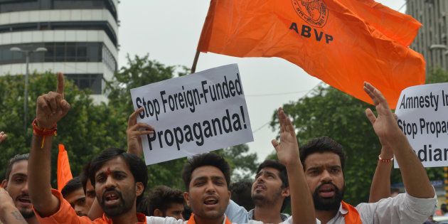 ABVP members shout slogans against human rights group Amnesty International India for their alleged anti-India stands on 17 August, 2016 in New Delhi.
