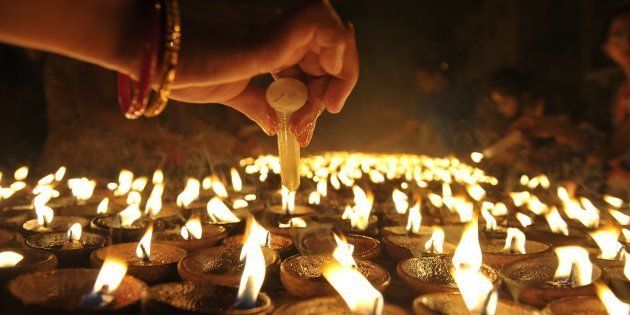 File photo of Indian Hindu devotees perform a ritual by lighting diyas - earthen lamps on Diwali.