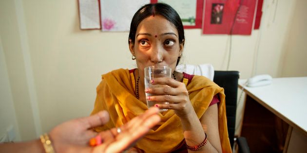 A surrogate mother in New Delhi takes one of her many daily doses of medicine.Eggs from Europeans, semen from wealthy Westerners and embryos planted in desperate women's bodies. The Indian baby factories have become a growing multi-billion dollar industry.. (Photo by Jonas Gratzer/LightRocket via Getty Images)