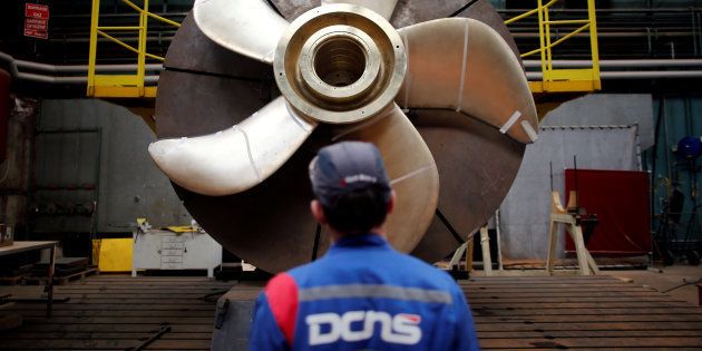 An employee looks at the propeller of a Scorpene submarine at the industrial site of the naval defence company and shipbuilder DCNS in La Montagne near Nantes, France, 26 April, 2016.