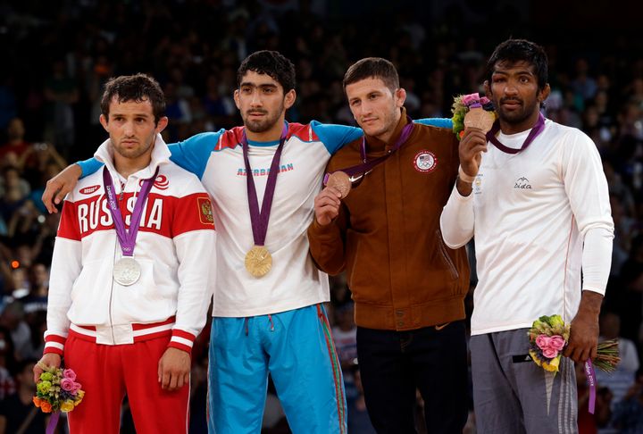 [File Photo] (L-R) Silver medalist Besik Kudukhov of Russia, gold medalist Toghrul Asgarov of Azerbaijan, bronze medalist Coleman Scott of the United States and bronze medalist Yogeshwar Dutt of India.