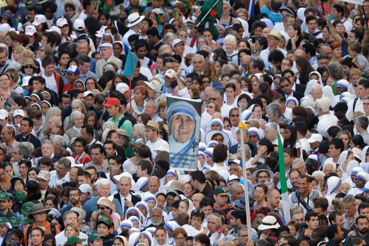 Faithful and pilgrims wait to enter in St. Peter's Square at the Vatican before the canonisation ceremony.