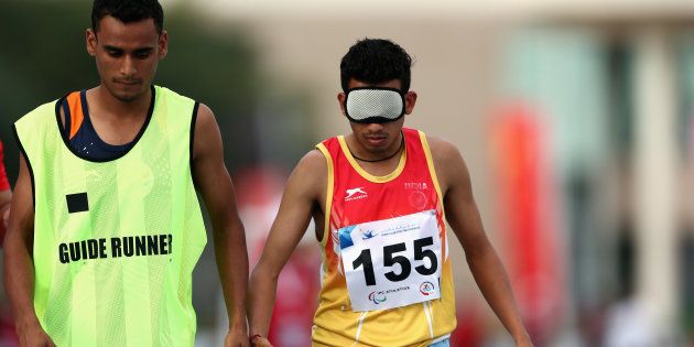 Ankur Dhama races in the Men's 400m T12 final during the IPC Athletics Asia-Oceania Championships at Dubai Police Stadium on March 8, 2016 in Dubai, United Arab Emirates.