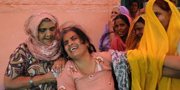 Bereaved family members of Preeti Rathi who died of injuries following an acid attack in Mumbai at her home in Narela village on 3 June, 2013 in New Delhi, India.