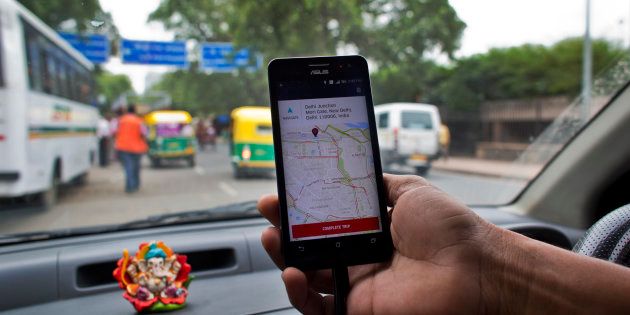 An Indian cab driver displays the city map on a smartphone provided by Uber as he drives in New Delhi.