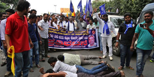 Activists lie on the ground as they shout slogans to protest against a recent Supreme Court order on a river water sharing dispute, in Bangalore, in the southern Indian state of Karnataka, Friday, Sept. 9, 2016.