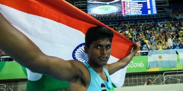 India's Mariyappan Thangavelu poses after winning the gold medal in the men's final high jump - T42 during the Paralympic Games at the Olympic Stadium in Rio de Janeiro.