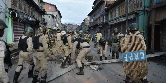 Indian security forces clear road blockades following clashes with Kashmiri protestors in Srinagar on August 29, 2016.