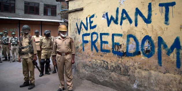 In this Aug. 12, 2016, file photo, Indian policemen stand guard during a curfew in Srinagar.