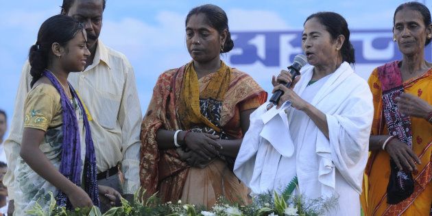 KOLKATA, INDIA - SEPTEMBER 14: West Bengal Chief Minister Mamata Banerjee hands over land ownership documents to farmers at the Singur Divas Celebration rally at Singur in Hooghly. (Photo by Subhendu Ghosh/Hindustan Times via Getty Images)