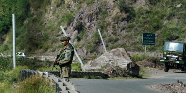 An Army man stand guards near Army Brigade camp during a terror attack in Uri, Jammu and Kashmir on Sunday.
