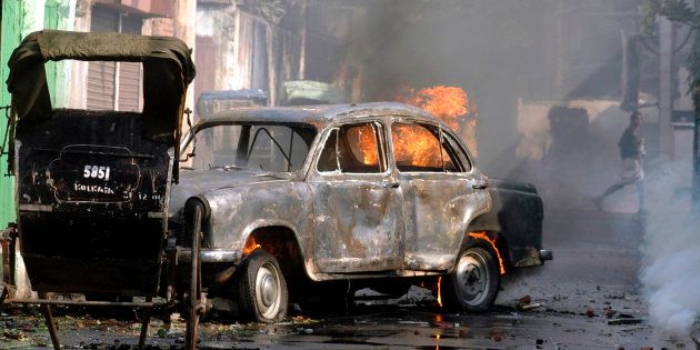 File photo of a car torched by protestors during a protest march in Kolkata, November 21, 2007.