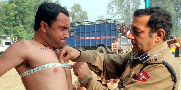 File photo of a police officer measuring the chest of a man during a recruitment drive in J&K.