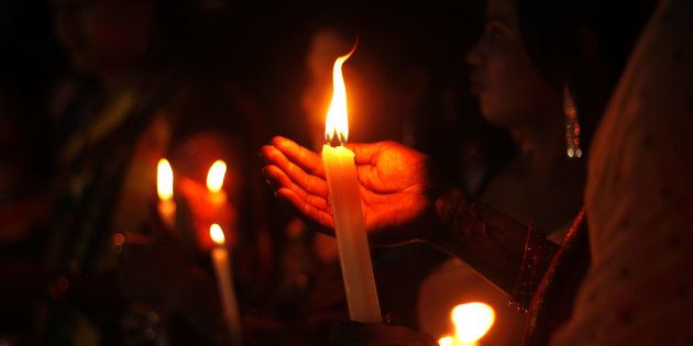 Members of the transgender community holds candle lights as they pray for soldiers killed in Uri, Kashmir.