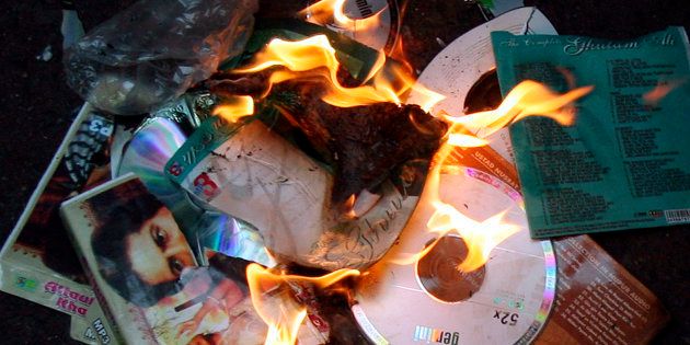 Members of MNS burn music disks of Pakistani artists during a protest against Pakistan government in Mumbai.