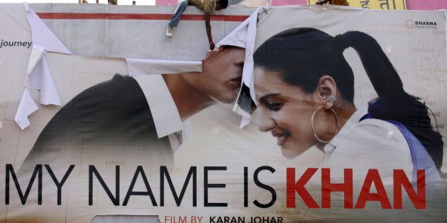 Supporters of Hindu hardline group Shiv Sena tear a poster of Bollywood actor Shah Rukh Khan's film
