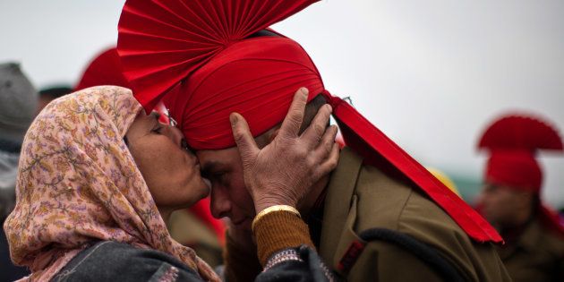 File photo of a Kashmiri Muslim woman kissing her son after his passing out parade.