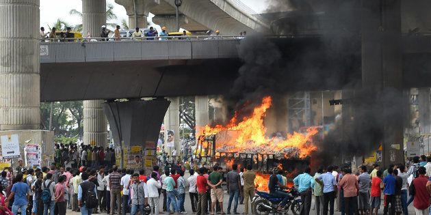A vehicle is set alight by pro-Karnataka activists as the Cauvery water dispute erupted following the Supreme Court's order to release water to Tamil Nadu, in Bangalore on September 12, 2016.MANJUNATH KIRAN/AFP/Getty Images.
