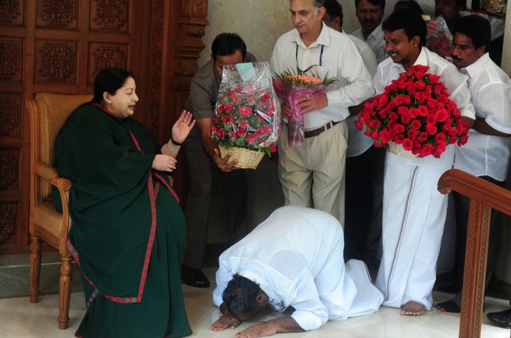 A party cadre prostrates himself at the feet of Jayalalithaa Jayaram as she gestures at her residence in Chennai on May 19, 2016. ARUN SANKAR/AFP/Getty Images