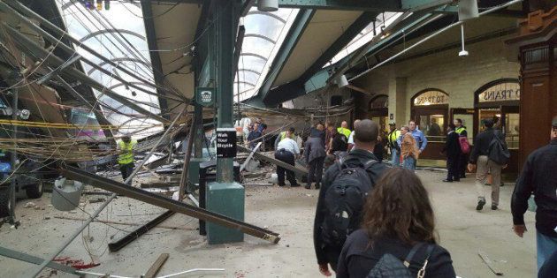 This photo provided by Ian Samuel shows the scene of a train crash in Hoboken, N.J., on Thursday, Sept. 29, 2016. A commuter train barreled into the New Jersey rail station during the Thursday morning rush hour, causing serious damage. The train came to a halt in a covered area between the station's indoor waiting area and the platform. A metal structure covering the area collapsed. ( Ian Samuel via AP)