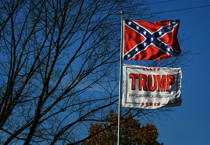 The Confederate Flag and a Trump MAGA flag fly along the Lincoln Highway near a video store in Chester, West Virginia. (Photo