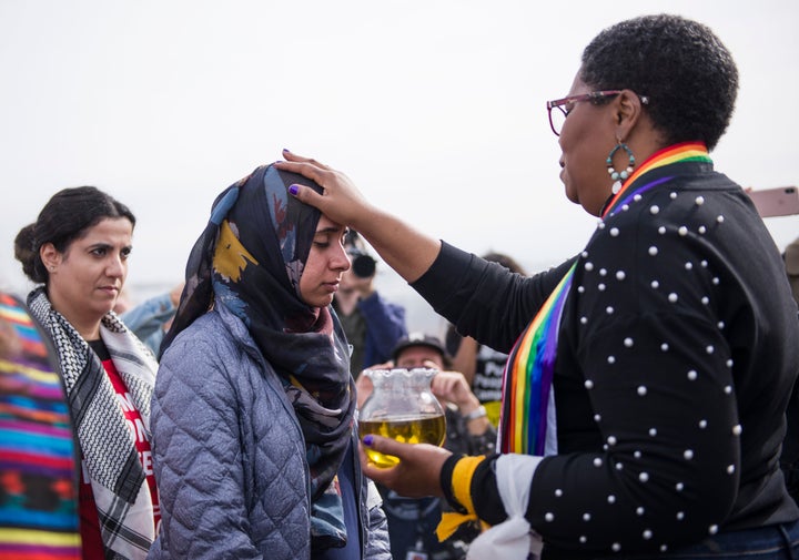 Zahra Billoo, executive director of CAIR's San Francisco Bay Area chapter, receives a blessing from Rev. Traci Blackmon, executive minister of justice and local church ministries for the United Church of Christ, during an interfaith action in San Diego.