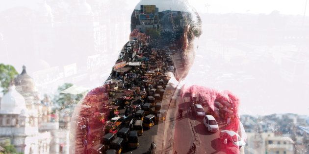 double exposure of a woman and Indian cityscape