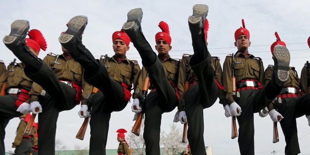 Indian army recruits wearing their ceremonial uniform perform a salute as they pose before their passing out parade at a garrison in Rangreth.