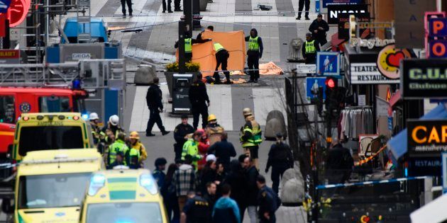 TOPSHOT - Emergency services work at the scene where a truck crashed into the Ahlens department store at Drottninggatan in central Stockholm, April 7, 2017. / AFP PHOTO / Jonathan NACKSTRAND
