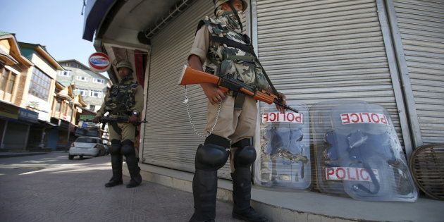 Indian Central Reserve Police Force (CRPF) personnel stand guard in front of closed shops during a strike in Srinagar June 17, 2015.