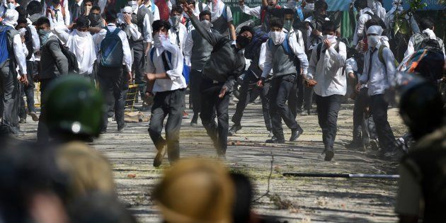 Kashmiri students clash with Indian government forces near a college in central Srinagar's Lal Chowk on April 17, 2017.