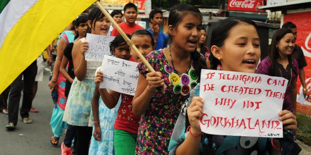 Indian school children hold placards and party flags as they take part in a rally for the support of Gorkhanland during a day long relaxation of an indefinite strike at Sukna village on the outskirts of Siliguri on August 31, 2013.