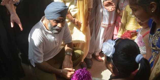Canada's Defence Minister Harjit Singh Sajjan (C) talks to children during his visit to the All India Pingalwara Charitable Society at Manawala village on the outskirts of Amritsar on 20 April 2017.