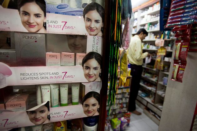 A pharmacy manager works in his shop where beauty and fairness products are displayed in Mumbai, India, on Wednesday, Nov. 11, 2009.