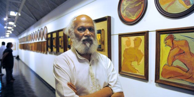 Indian artist Jatin Das poses at an art exhibition in Ahmedabad.