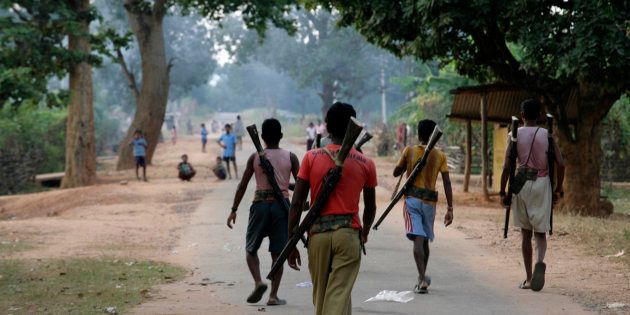 This file photo shows special police officers walking at a Salwa Judum, or purification hunt camp in Dantewada.