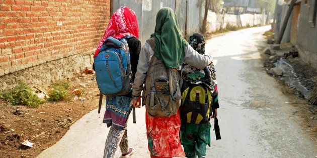 Kashmiri students walk home after attending an ad-hoc learning center on the outskirts of Srinagar.